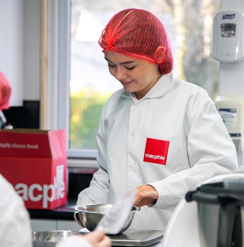 Lily-Anna Barclay weighing out ingredients in a Macphie branded baker's jacket