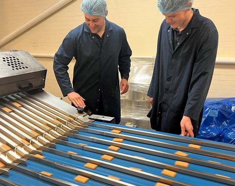 Elkes Biscuits factory service technician Aidan Fowell (left) and electrical engineer Connor Gratton check a biscuit production line