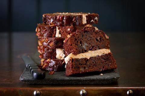 Slices of a Sticky Pecan Loaf cake with frosting in the middle