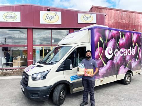 Regal Foods - Man holds products launched family on Ocado outside their head office in Bradford