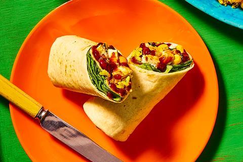 A tortilla wrap with spinach, chicken, pineapple and kidney beans in