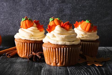 Pumpkin spice cakes with edible mini pumpkins and frosting on top