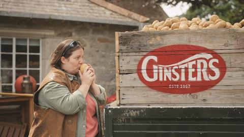 A woman kissing a potato as part of Ginsters' 'Taste the Effort' campaign