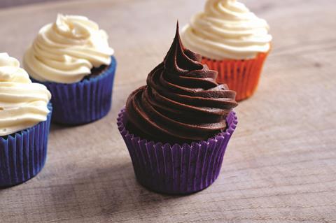 A chocolate cupcake with chocolate frosting on top