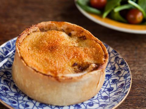 A Scotch pie on a blue & white plate