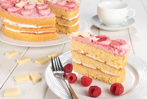 A three layer cake with raspberry buttercream on top