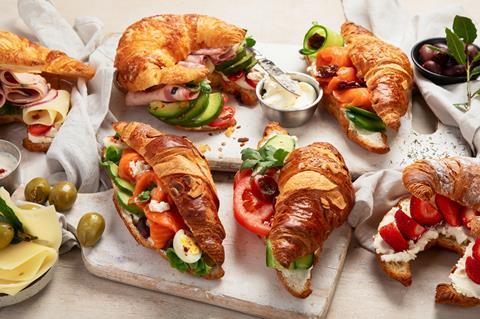 A selection of croissants with savoury fillings like ham, cheese, salmon, cucumber, and tomator