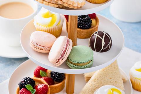 Afternoon tea stand with macarons, fruit tarts, and more