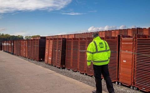 An inspector with Bakers Basco crates