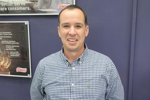 Steve Jones in a chequered shirt against a purple background