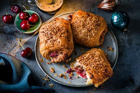 Cherry Stollen Croissants on a blue plate with baubles at the side