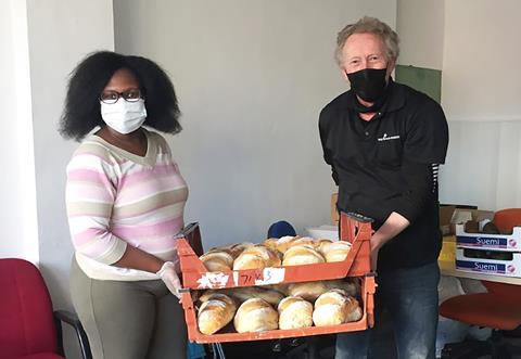 Irene Kabuye of Ubuntu Multicultural Centre takes delivery of bread with Big River Bakery founder, Andy Haddon