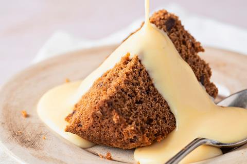 Sticky Toffee Pudding with cream being poured on top