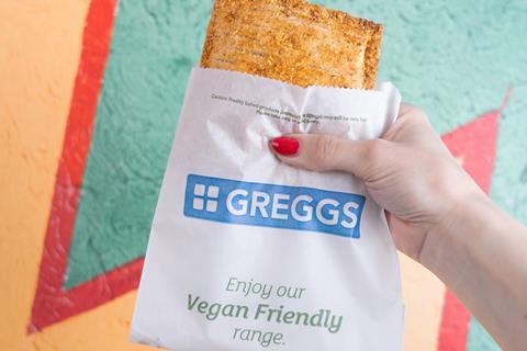 Greggs' new Vegan Mexican Chicken-Free Bake in a paper takeaway bag held by a female hand.