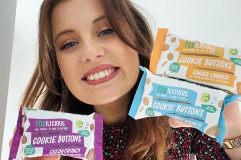 Fodilicious founder Lauren Leisk holds the relaunched Cookie Buttons varieties