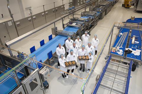 Jones Village Bakery staff pose at its £16m artisan bread production line upon opening in 2022