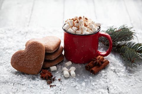 Hot chocolate loaded with mini marshmallows and gingerbread heart-shaped biscuits