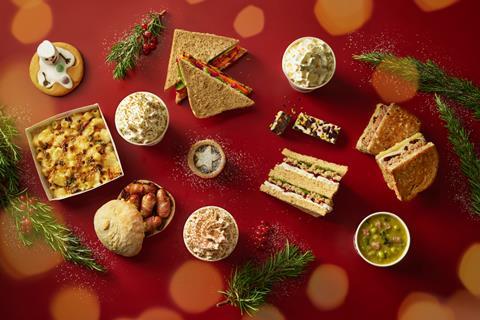 A bird's eye view of the Pret Christmas menu with sandwiches, pigs in blankets, mince pies, and coffees