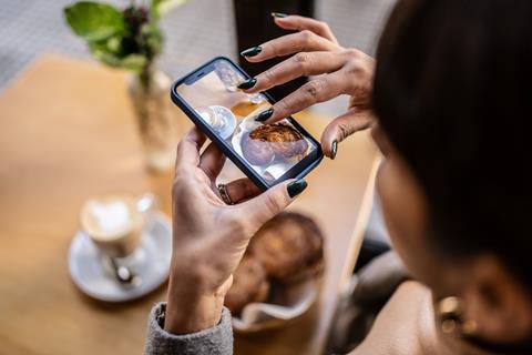 Woman taking photo of baked goods