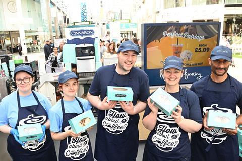 Cinnabon workers at the Bullring in Birmingham display boxes of products  2100x1400