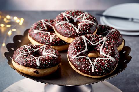 A stack of Christmas doughnuts on a cake stand