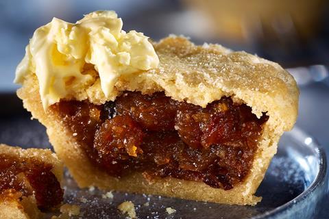 A mince pie cut in half with clotted cream on top