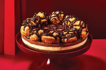 A chocolate cheesecake topped with profiteroles