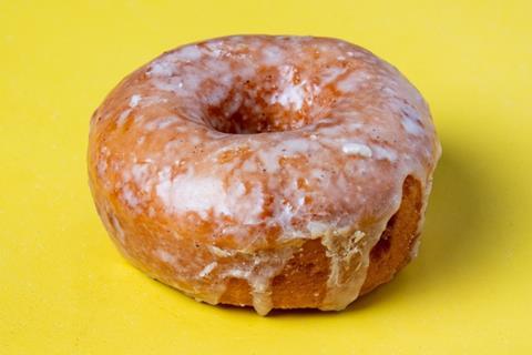 A Original Vanilla Bean Glaze Doughnut on yellow background