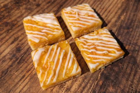 Clementine and Almond cake squares with white icing drizzle on top