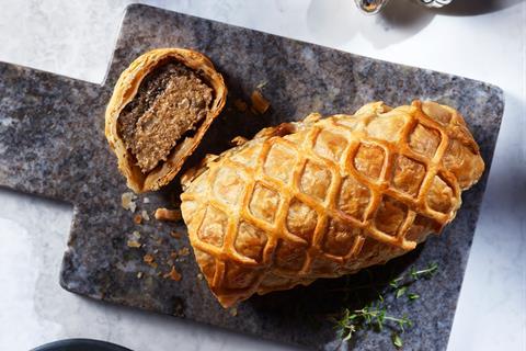 A vegan porcini mushroom wellington on grey marble board