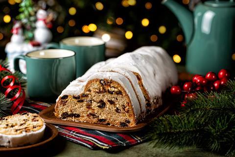 A festive stollen sliced to show the dried fruit inside