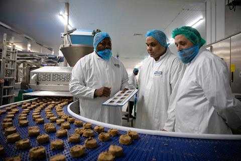 Workers at Wrights factory in Crewe watch the new cookie line