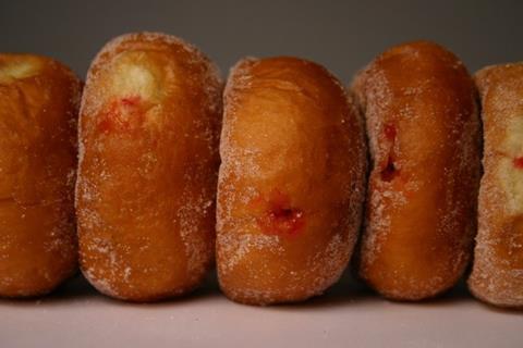 A row of sticky jam doughnuts