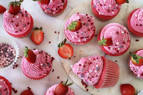 Pink cupcakes with pink frosting and strawberries on top