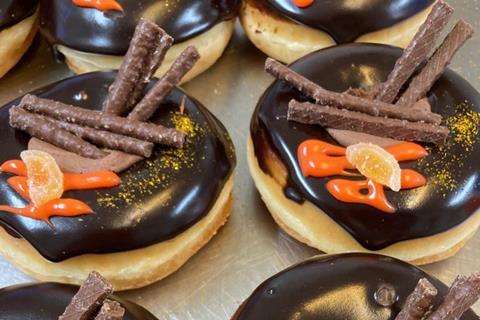 Chocolate covered rung doughnuts with Orange Matchmaker sweets and orange drizzle