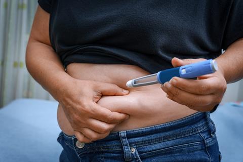 Person injecting GLP-1 into stomach