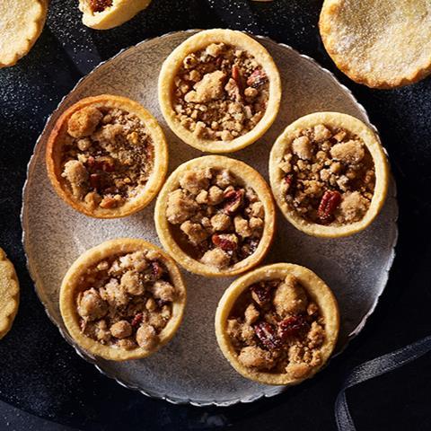 Crumble topped spiced apple tarts on a silver plate