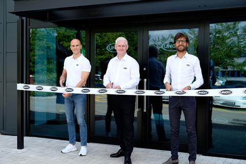 Three men in white shirts outside the Unox UK Customer Expereince Centre