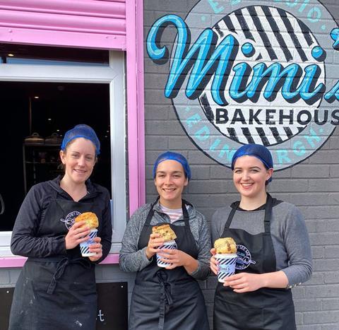 Mimi's Bakehouse staff hold scones and takeaway coffee cups outside a bakery hatch at one of their Edinburgh cafes  1034x1008