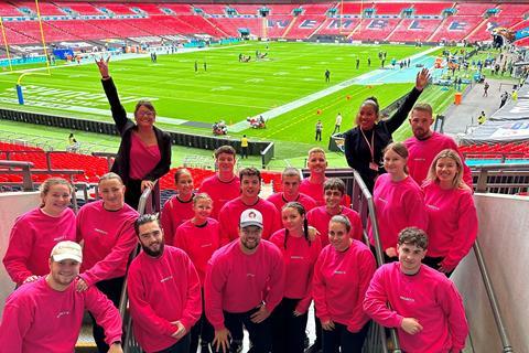A group of people in bright pink jumpers at Wembley Stadium