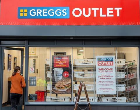 A woman in an orange cardigan walking into a Greggs outlet