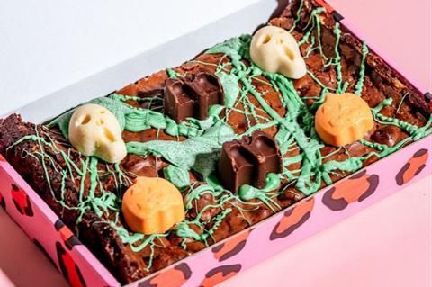 Brownies splattered with green icing and chocolate skulls and pumpkins