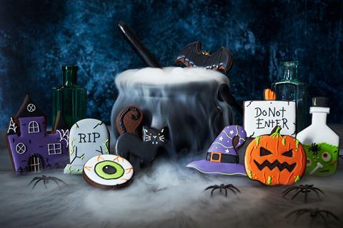 Halloween biscuits in the shape of a haunted house, flying bat, cat, 'do not enter' sign, pumpkin, gravestone and more