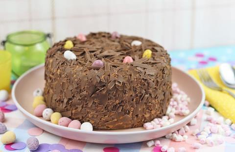 A chocolate cake covered in chocolate shavings and mini eggs