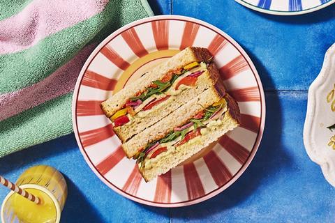 A Roasted Veg and Mozzarella sandwich on a stripy red plate