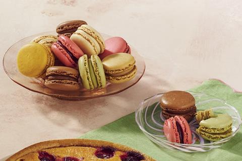 Colourful macarons in a glass dish