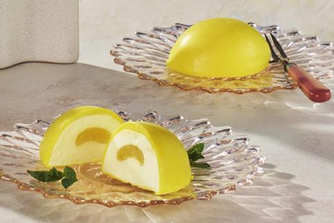 Lemon illusion desserts on a glass cake stand