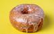 A Original Vanilla Bean Glaze Doughnut on yellow background